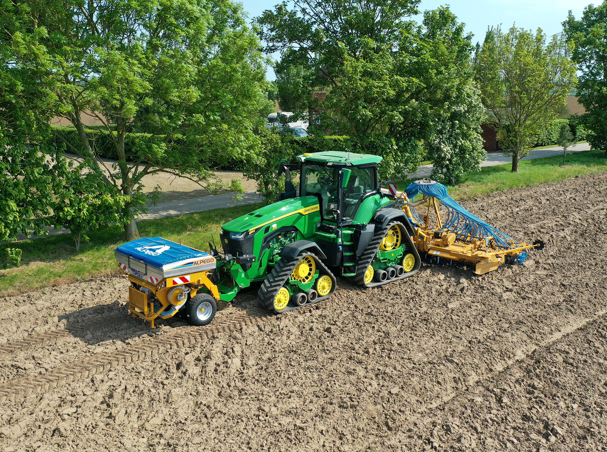 Alpego ASPro and DTEK Power Harrow Combination Drill in field on John Deere 8RX