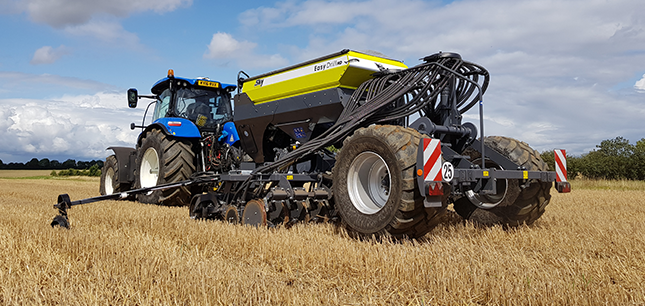 4m Sky Agriculture EasyDrill drilling into stubble behind a New Holland tractor